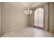 Bright dining area featuring elegant chandelier, light beige walls and tile floors at 1675 Se 73Rd Pl, Ocala, FL 34480