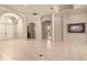 Spacious foyer with tile flooring, arched entrances, and double doors leading to another room at 1675 Se 73Rd Pl, Ocala, FL 34480