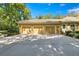 Three-car garage with a large driveway and well-maintained exterior at 1675 Se 73Rd Pl, Ocala, FL 34480