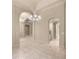 Hallway with archways leading to other rooms, tile flooring, and neutral color scheme at 1675 Se 73Rd Pl, Ocala, FL 34480
