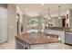 Well-appointed kitchen featuring granite countertops, a breakfast bar, and pool views at 1675 Se 73Rd Pl, Ocala, FL 34480