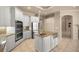 Open kitchen with a stainless steel refrigerator, double oven, granite countertops, and center island at 1675 Se 73Rd Pl, Ocala, FL 34480