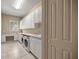 Spacious laundry room featuring modern washer and dryer, lots of cabinets and tile flooring at 1675 Se 73Rd Pl, Ocala, FL 34480