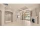 Large living room featuring fireplace, ceiling beams, and glass sliders to patio area at 1675 Se 73Rd Pl, Ocala, FL 34480