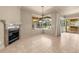 Bright living area with a fireplace and views of the screened-in lanai and pool at 1675 Se 73Rd Pl, Ocala, FL 34480