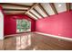 Living room boasting wood floors, a window with a view, and vaulted ceilings with beams at 1675 Se 73Rd Pl, Ocala, FL 34480