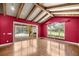 Vaulted living room with hardwood flooring, exposed beams, and sliding glass doors to the pool at 1675 Se 73Rd Pl, Ocala, FL 34480