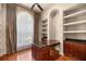 Elegant office features custom built-ins, desk with granite counters, and a large window letting in lots of natural light at 1675 Se 73Rd Pl, Ocala, FL 34480