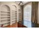 Bright office space featuring built-in shelving, wood floors, a ceiling fan, and a window that allows for plenty of sunlight at 1675 Se 73Rd Pl, Ocala, FL 34480