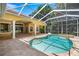 Outdoor swimming pool and attached jacuzzi within screened-in patio at 1675 Se 73Rd Pl, Ocala, FL 34480