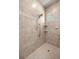 The shower features neutral tiling, a rainfall shower head, a shower handle, and a small window at 1675 Se 73Rd Pl, Ocala, FL 34480