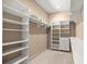 Large walk-in closet with custom shelving and drawers for all of your storage needs at 1675 Se 73Rd Pl, Ocala, FL 34480