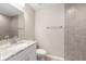 Bathroom with stylish marble countertops, modern fixtures, and a tiled shower and wall at 21301 Sw Rainbow Lakes Blvd, Dunnellon, FL 34431