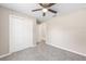 Bright bedroom featuring neutral walls, plush carpeting, and a modern ceiling fan with ample closet space at 21301 Sw Rainbow Lakes Blvd, Dunnellon, FL 34431