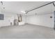 Spacious and well-lit garage featuring an opener and concrete flooring at 21301 Sw Rainbow Lakes Blvd, Dunnellon, FL 34431