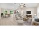 Open-concept living room and kitchen area with natural light, stylish furniture, and vaulted ceilings at 21301 Sw Rainbow Lakes Blvd, Dunnellon, FL 34431