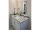 Bright bathroom vanity featuring granite countertops, storage, and modern fixtures at 2215 Ne 16Th Ct, Ocala, FL 34470