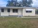 Charming single-story home with a well-maintained front yard, inviting porch, and functional awning adding curb appeal at 2215 Ne 16Th Ct, Ocala, FL 34470