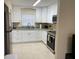 Well-equipped kitchen featuring white cabinets, granite countertops, and stainless steel appliances at 2215 Ne 16Th Ct, Ocala, FL 34470