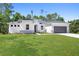 Charming one-story home with a well-manicured lawn and a two-car garage at 2254 Amberly Ave, Orlando, FL 32833