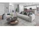 Open-concept living room with a sofa, chairs, and a view into the kitchen at 2254 Amberly Ave, Orlando, FL 32833