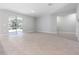 Empty room featuring tile floors, neutral paint, and a sliding glass door at 2254 Amberly Ave, Orlando, FL 32833