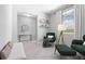 Bright living room featuring two chairs, a window, and tile floors at 2254 Amberly Ave, Orlando, FL 32833