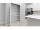Spacious walk-in pantry with ample shelving for organized storage adjacent to a modern kitchen at 2254 Amberly Ave, Orlando, FL 32833