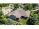 Aerial view of the home highlighting the roof, backyard, screened in patio, and lush landscaping at 2417 Se 23Rd St, Ocala, FL 34471