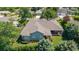 Aerial view of the home highlighting the roof, backyard, screened in patio and mature landscaping at 2417 Se 23Rd St, Ocala, FL 34471