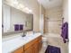 Bathroom with single vanity, tub-shower combo, purple accents, and modern fixtures, offering a functional and stylish space at 2417 Se 23Rd St, Ocala, FL 34471