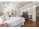Bedroom with wood floors, recessed lighting, and tray ceiling, offering a view of the outside through french doors at 2417 Se 23Rd St, Ocala, FL 34471