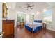 Bedroom with wood floors, ceiling fan, and natural light from windows, offering a relaxing and welcoming atmosphere at 2417 Se 23Rd St, Ocala, FL 34471