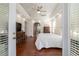 View from the doorway of a bedroom with wood floors, ceiling fan, tray ceilings, and access to the bathroom at 2417 Se 23Rd St, Ocala, FL 34471