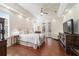 Bright bedroom features wood floors, tray ceiling, recessed lighting, and a ceiling fan, with doors to the outside at 2417 Se 23Rd St, Ocala, FL 34471