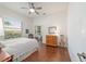 Bedroom with wood floors, ceiling fan, and natural light from windows, showcasing a peaceful and serene ambiance at 2417 Se 23Rd St, Ocala, FL 34471
