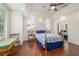 Bedroom with wood floors, ceiling fan, and natural light from windows, offering a comfortable and inviting space at 2417 Se 23Rd St, Ocala, FL 34471