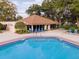Community pool with lounge chairs and tables are surrounded by mature landscaping and a large clubhouse at 2417 Se 23Rd St, Ocala, FL 34471