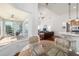 Dining area with glass table, sunroom, and view into living room and modern kitchen at 2417 Se 23Rd St, Ocala, FL 34471