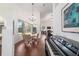 Bright dining area featuring a glass table, elegant chandelier, and a large window with a view of the outdoors at 2417 Se 23Rd St, Ocala, FL 34471