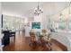 Light-filled dining area with hardwood floors, decorative chandelier and sunroom at 2417 Se 23Rd St, Ocala, FL 34471