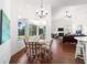 Dining area with chandelier overlooking the living room and outdoor views from the sunroom at 2417 Se 23Rd St, Ocala, FL 34471