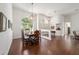 Open-concept dining room showcases hardwood flooring, decorative lighting, and a view into the living room at 2417 Se 23Rd St, Ocala, FL 34471