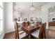 Dining room featuring hardwood flooring, open-concept design, and ornate chandelier at 2417 Se 23Rd St, Ocala, FL 34471
