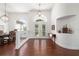 Open-concept entryway features hardwood flooring, dining room and decorative glass paneled front doors at 2417 Se 23Rd St, Ocala, FL 34471