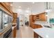 Open kitchen features wood cabinets, island, stainless appliances, and easy access to the dining area at 2417 Se 23Rd St, Ocala, FL 34471