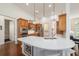 Bright eat-in kitchen boasts custom cabinets, pendant lights, island, and stainless steel appliances at 2417 Se 23Rd St, Ocala, FL 34471