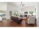 Open-concept living room featuring a fireplace, hardwood floors, and sliding glass doors to sunroom at 2417 Se 23Rd St, Ocala, FL 34471