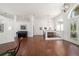 Open-concept living area features hardwood flooring, piano, and view of the dining room at 2417 Se 23Rd St, Ocala, FL 34471
