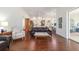 Open-concept living room with hardwood floors and a view into the sunroom and kitchen at 2417 Se 23Rd St, Ocala, FL 34471